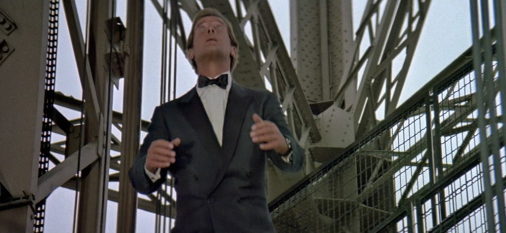 Roger Moore wearing a single button double breasted suit.