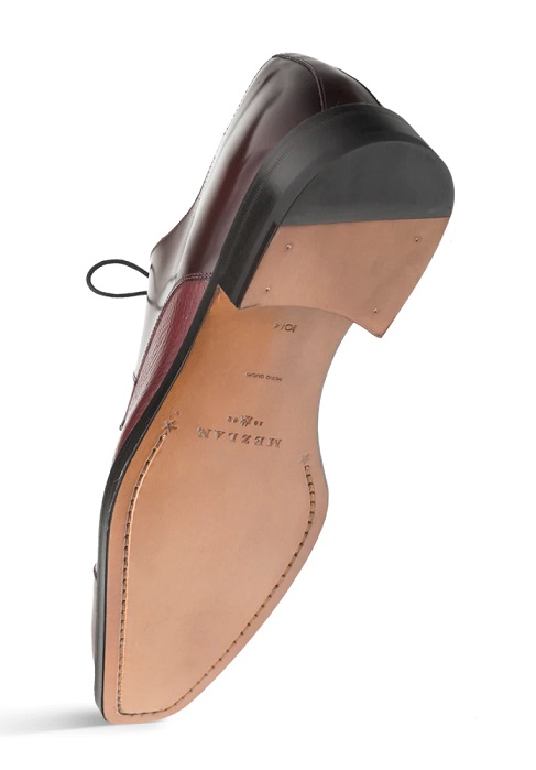 Dark burgundy leather lace-up shoe with a tan leather sole